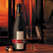 Load image into Gallery viewer, Bottle and glass of Goslings-Old-Family-Reserve-Rum on a wooden surface with a warm background