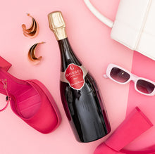 Load image into Gallery viewer, Bottle of Gosset Brut champagne with pink sunglasses and sandals on a pink background