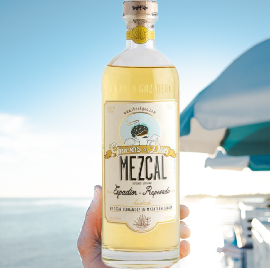 Load image into Gallery viewer, Bottle of Mezcal with a blurred background