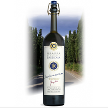 Load image into Gallery viewer, Bottle of Grappa Sassicaia with a scenic background