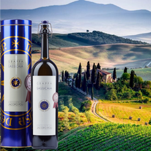 Load image into Gallery viewer, Grappa Sassicaia bottle and packaging with a scenic Italian landscape in the background