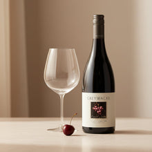 Load image into Gallery viewer, Bottle of Greywacke Pinot Noir wine with a glass and cherry on a neutral background