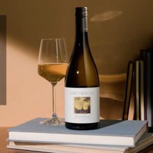 Load image into Gallery viewer, A bottle of Greywacke Sauvignon blanc wine and glass on come books on a table