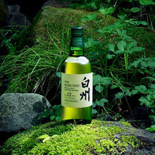 Load image into Gallery viewer, Hakushu 12 Year Old Single Malt Whisky on a rock covered in moss