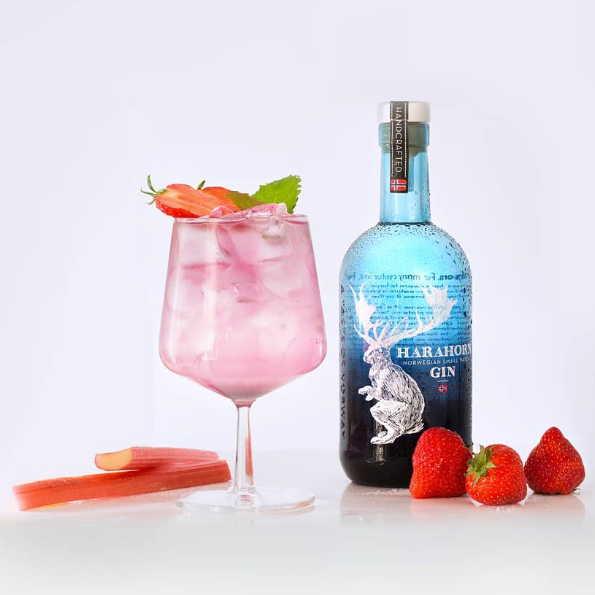 Load image into Gallery viewer, Harahorn Norwegian Small Batch Dry Gin 1000ml bottle with a pink cocktail and strawberries on a white background