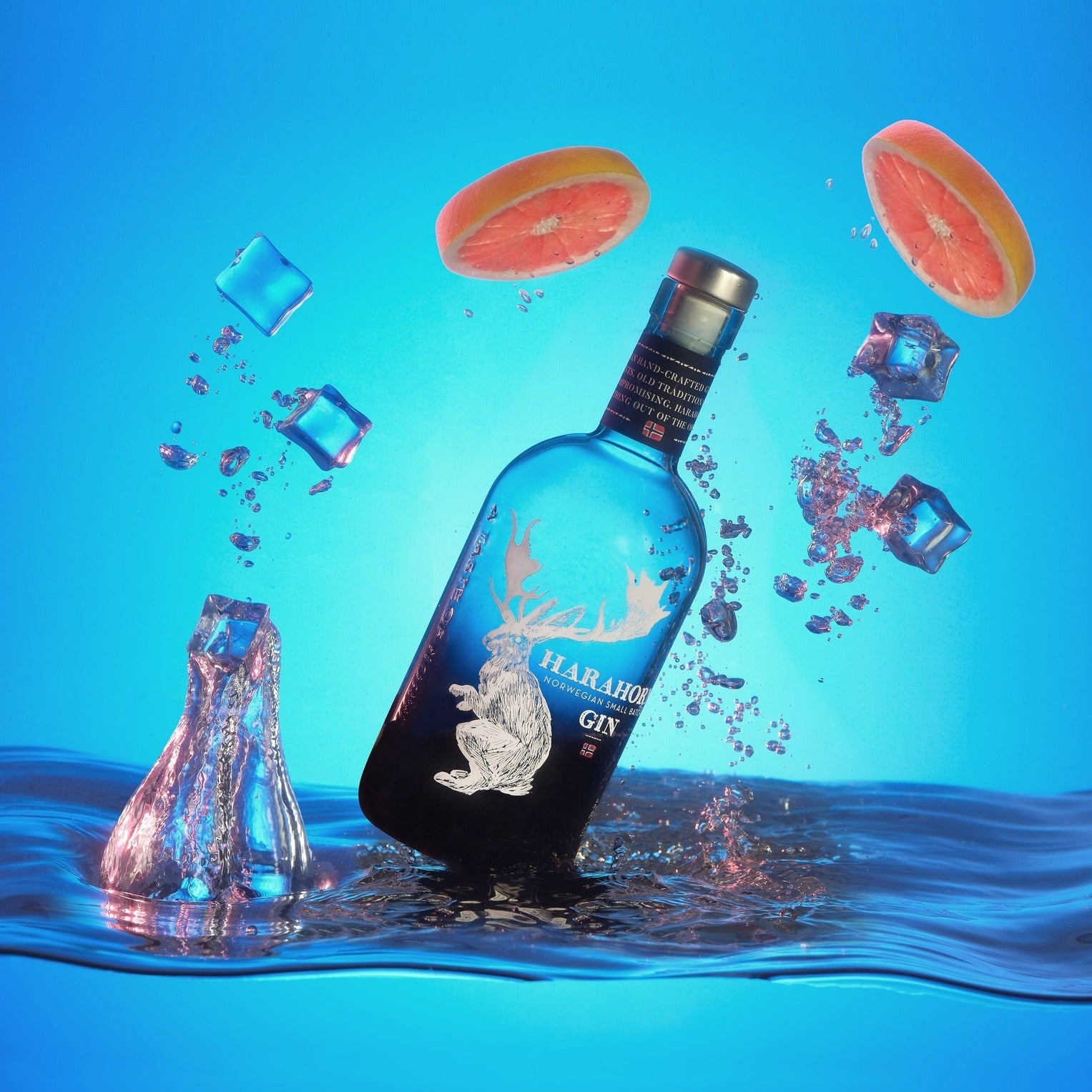 Load image into Gallery viewer, Harahorn Norwegian Small Batch Dry Gin 1000ml bottle with a deer design in water against a blue background