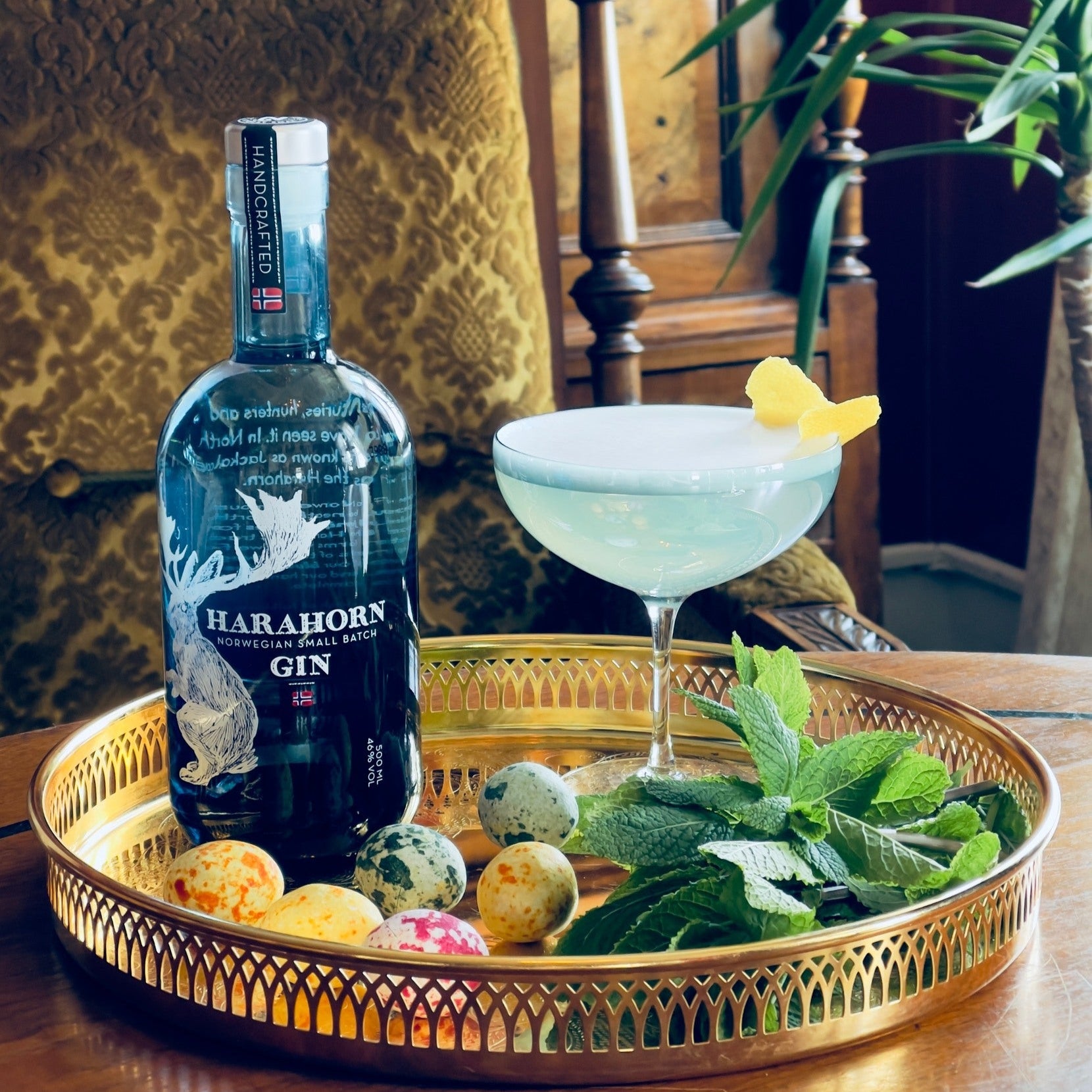 Load image into Gallery viewer, Bottle of Harahorn Gin with a cocktail and garnishes on a decorative tray.
