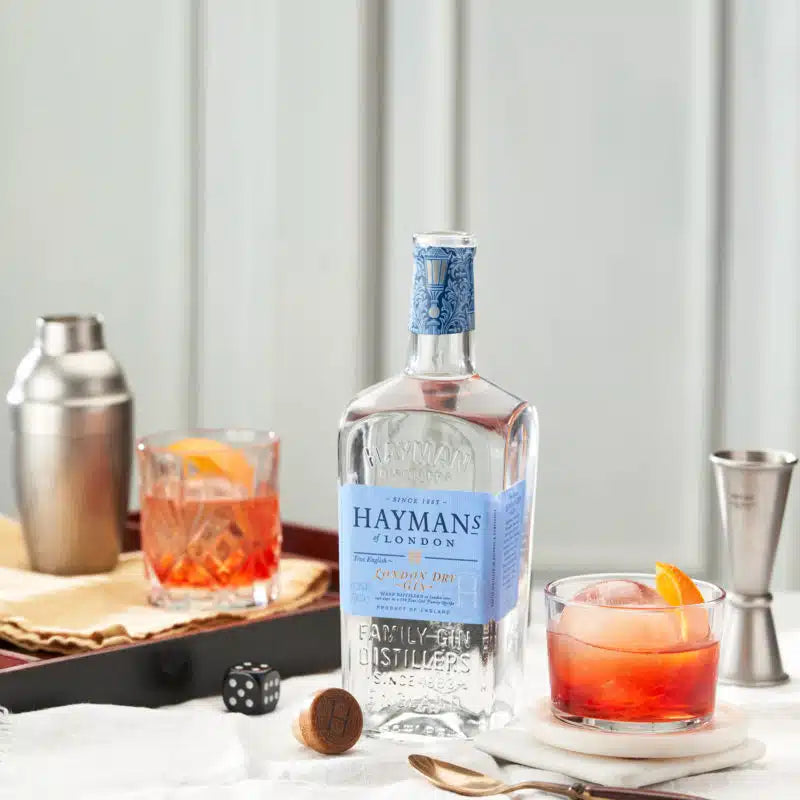 Load image into Gallery viewer, Hayman's London Dry Gin bottle with cocktails on a bar setup
