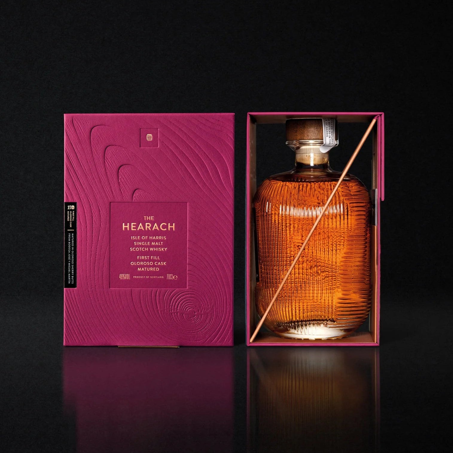 Load image into Gallery viewer, The Hearach Oloroso Cask Single Malt Scotch Whisky bottle with its stunning crimson packaging on a black background