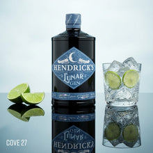 Load image into Gallery viewer, Hendrick's Lunar Gin bottle with a glass of gin and tonic and lime slices on a reflective surface.