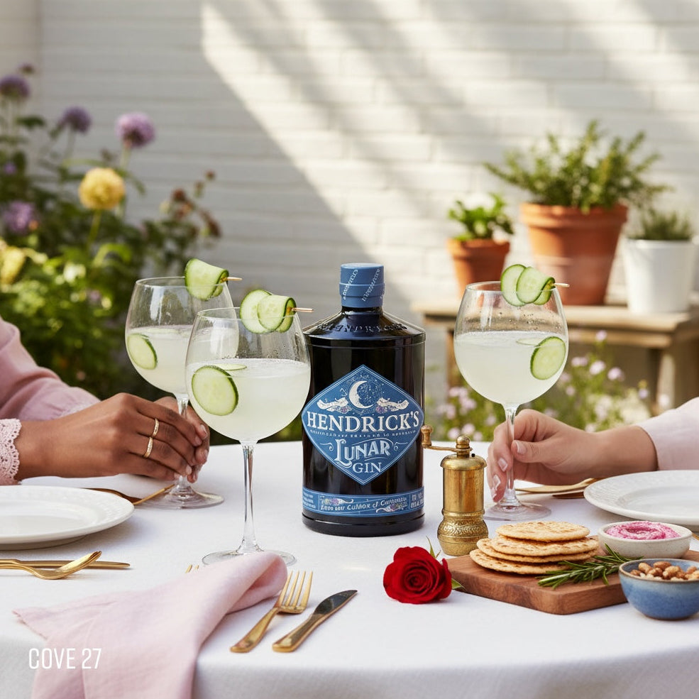 Load image into Gallery viewer, Hendrick's Lunar Gin bottle with glasses of gin and tonic on a table outdoors.