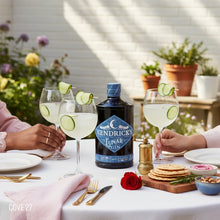 Load image into Gallery viewer, Hendrick's Lunar Gin bottle with glasses of gin and tonic on a table outdoors.