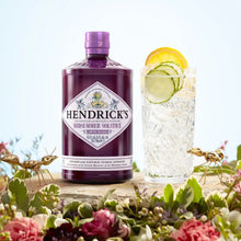 Load image into Gallery viewer, Hendrick&#39;s Misummer Solstice gin bottle with a cocktail and flowers on a light blue background