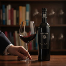 Load image into Gallery viewer, Henschke Henschke Keyneton Euphonium red wine bottle with a glass of red wine on a wooden table, blurred bookshelf in the background
