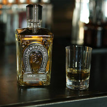 Load image into Gallery viewer, Bottle of Herradura tequila with a shot glass on a bar counter