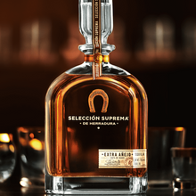 Load image into Gallery viewer, Bottle of Seleccion Suprema de Herradura tequila with a dark background