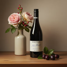 Load image into Gallery viewer, Hewitson-Ned-Henry-Shiraz bottle with flowers and cherries on a wooden surface
