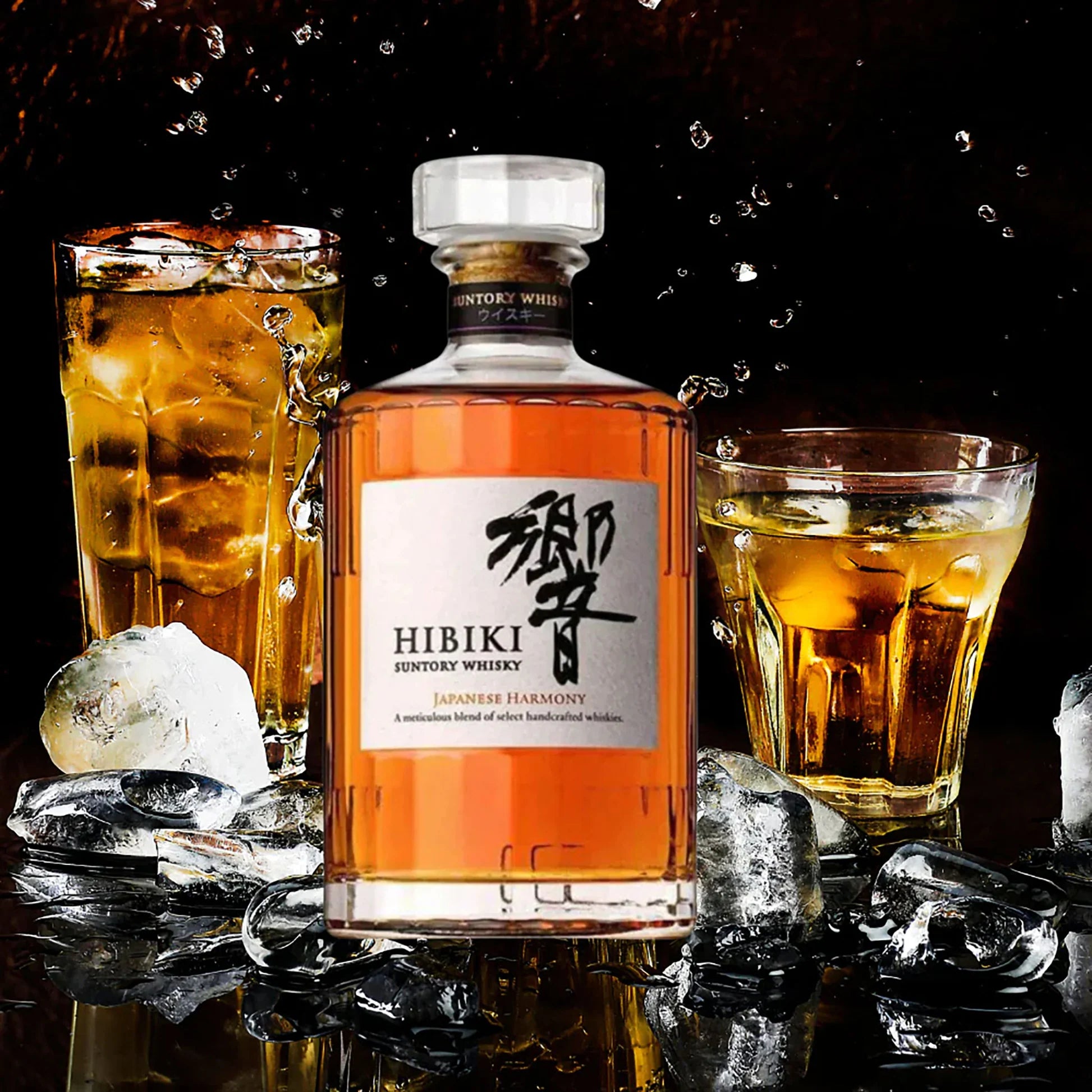 Load image into Gallery viewer, A bottle of japanese Habiki Whisky with a  couple of tumblers of neat whisky on a black background with splashing water