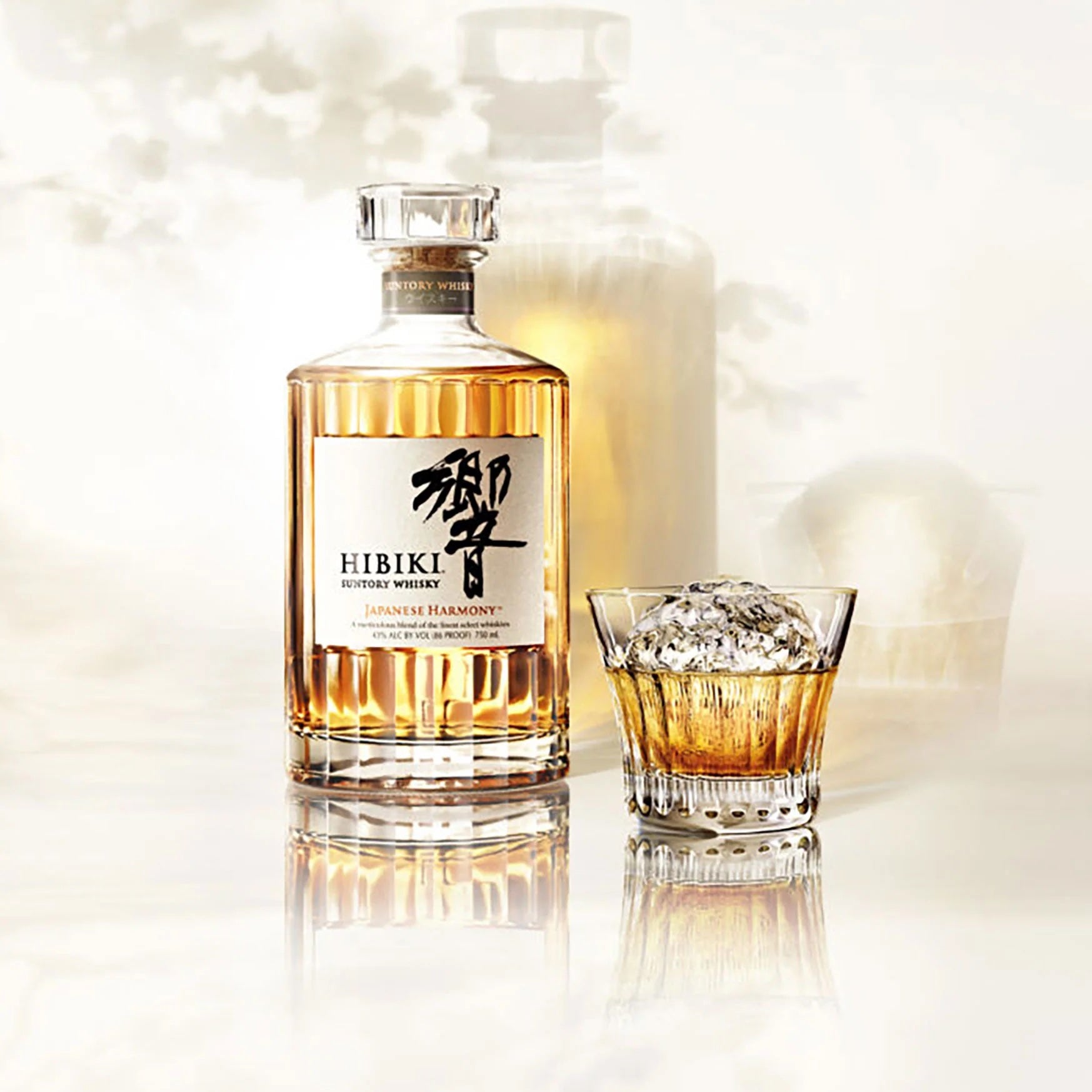 Load image into Gallery viewer, A bottle of japanese Habiki Whisky with a tumbler of neat whisky on a white background with shadows of the bottle and tumbler