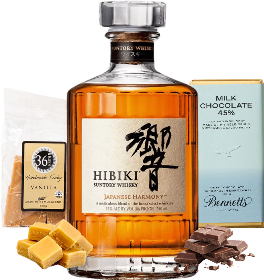 A bottle of Hibiki Harmony Japanese Whisky thats centred, flanked by a bag of 36 Degrees vanilla fudge, a bar of Bennett's milk chocolate, vanilla fudge squares, and chocolate pieces on a white background.
