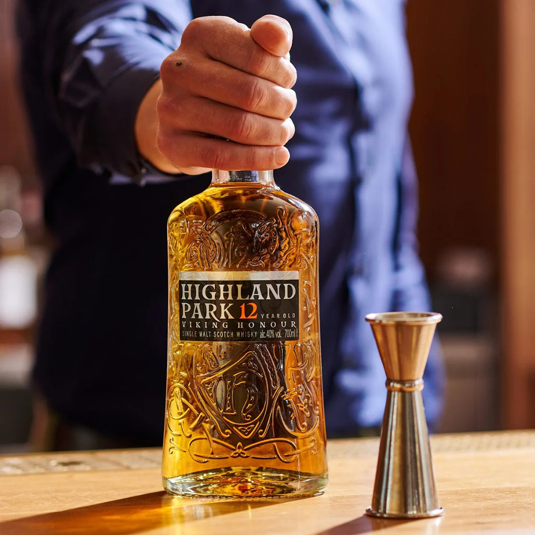 Load image into Gallery viewer, A man holding a bottle of whisky in his hand.