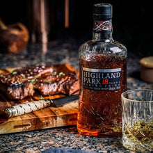 Load image into Gallery viewer, Highland Park 18-year-old whisky bottle with a steak and glass on a table