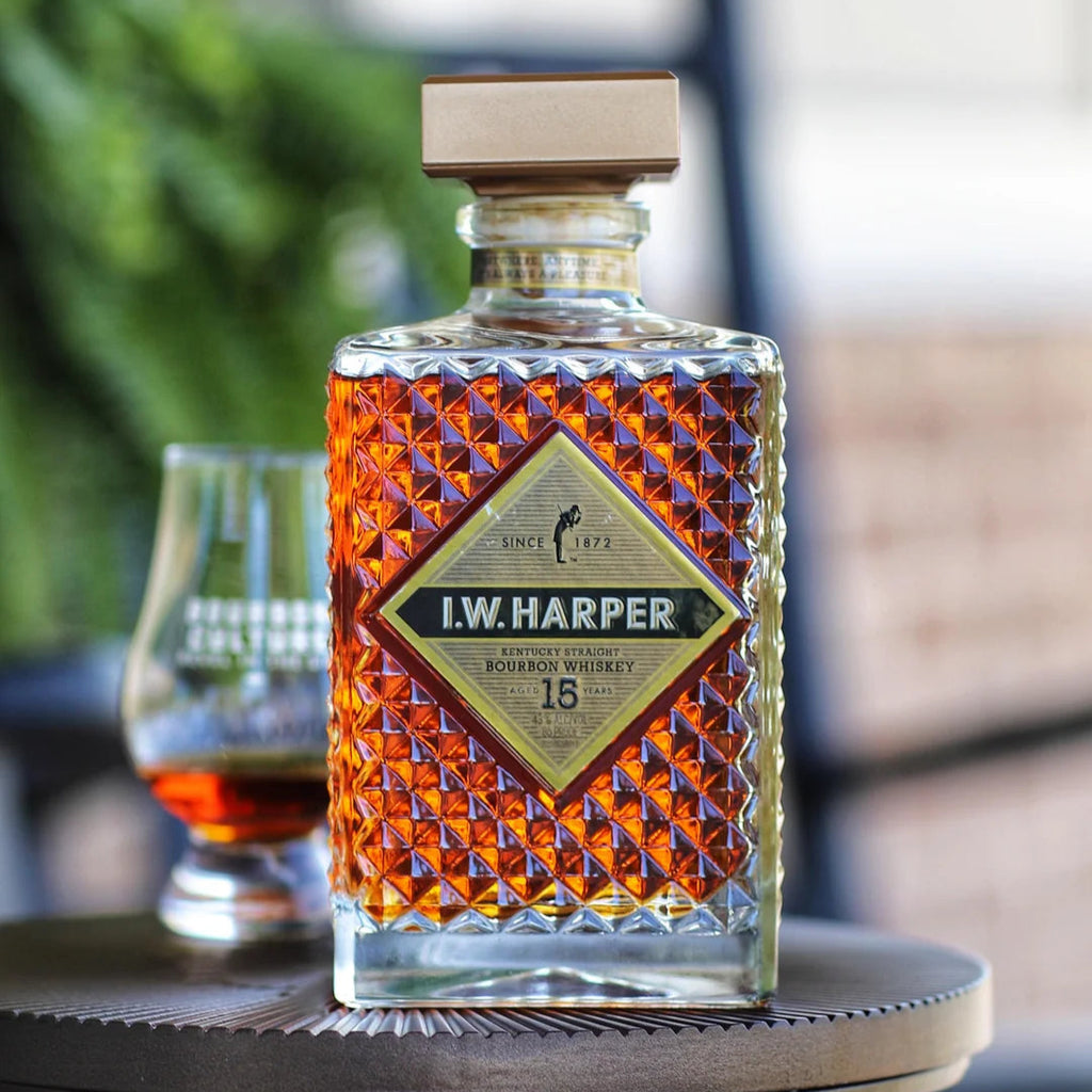 Bottle of I.W. Harper bourbon whiskey on a table with a blurred background