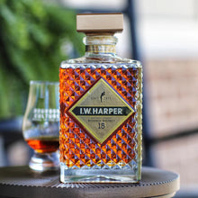 Load image into Gallery viewer, Bottle of I.W. Harper bourbon whiskey on a table with a blurred background