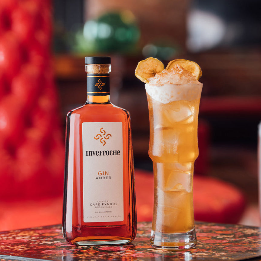 Bottle of Inverroche gin with a cocktail on a decorative table.