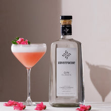 Load image into Gallery viewer, Inverroche Gin bottle with a cocktail and pink flowers on a white surface.
