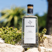 Load image into Gallery viewer, Bottle of Inverroche Gin on a rocky surface with a blurred natural background