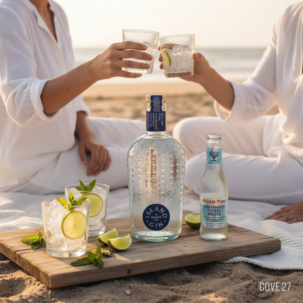 Load image into Gallery viewer, Two people sitting on a beach with bottles of Island Navy Strength Gin and Fever-Tree drinks.