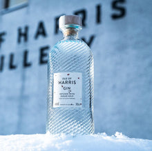 Load image into Gallery viewer, Bottle of Isle of Harris Gin in the snow with a blurred background