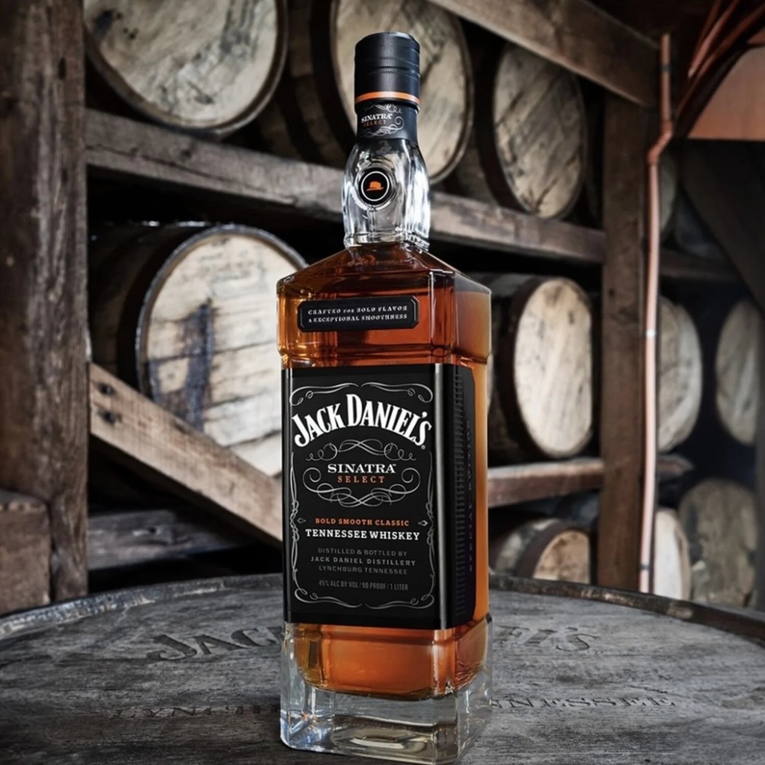 Load image into Gallery viewer, Jack Daniel's whiskey bottle in front of wooden barrels