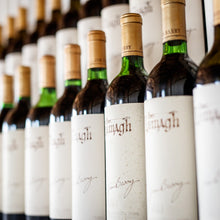 Load image into Gallery viewer, Row of Jim-Barry-The-Armagh-Shiraz wine bottles with labels in a store setting