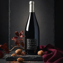 Load image into Gallery viewer, John-Duval-Eligo-Shiraz-lifestyle Wine bottle with a dark background and decorative elements