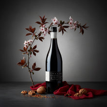 Load image into Gallery viewer, Bottle of John-Duval-Entity-Shiraz wine with cherry blossoms and nuts on a dark surface