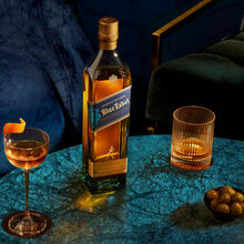 Load image into Gallery viewer, Johnnie Walker Blue Label bottle with a cocktail and olives on a dark surface