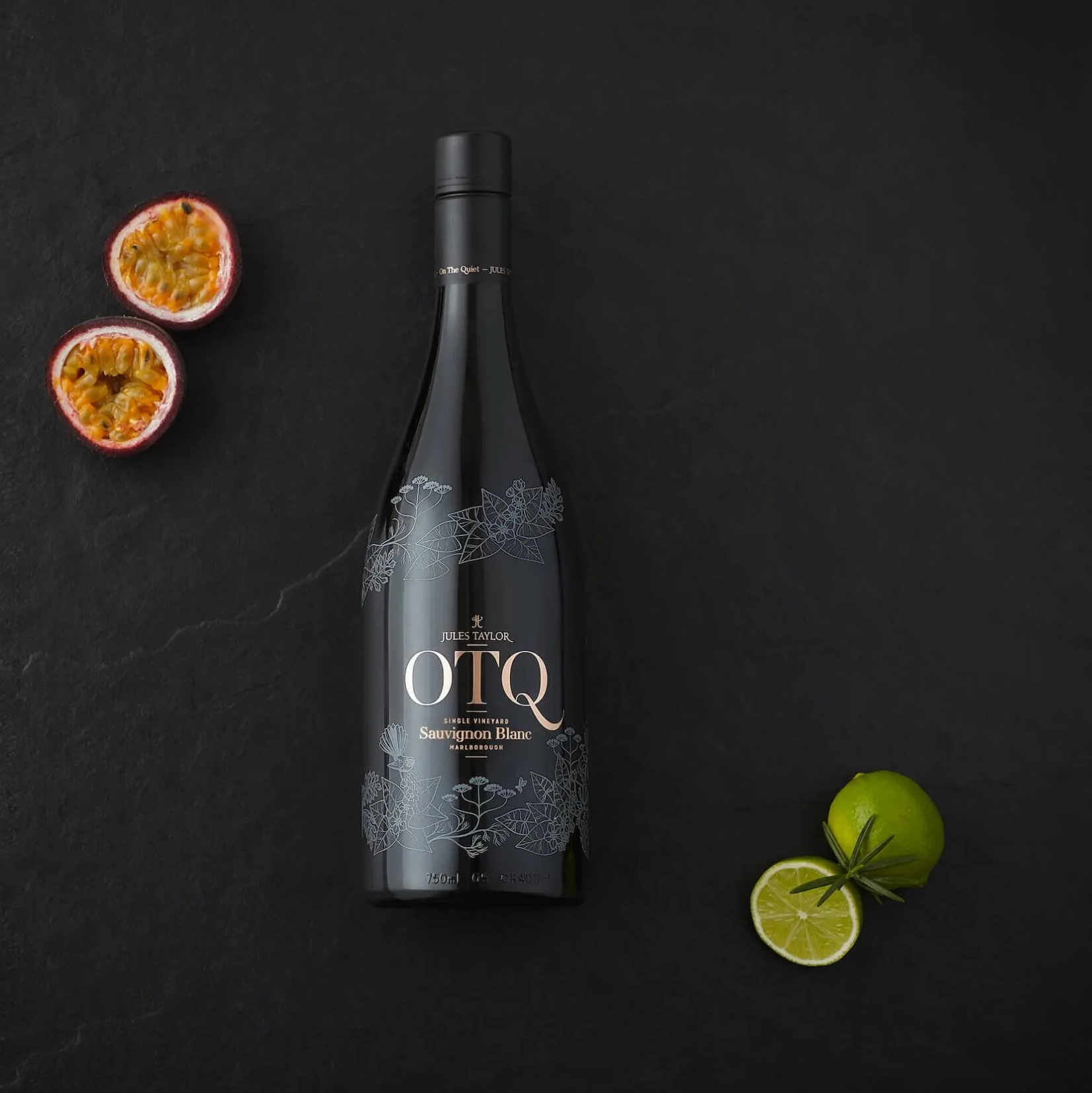 Load image into Gallery viewer, A bottle of Jules Taylor OTQ Sauvignon Blanc white wine with some fruit on a black background