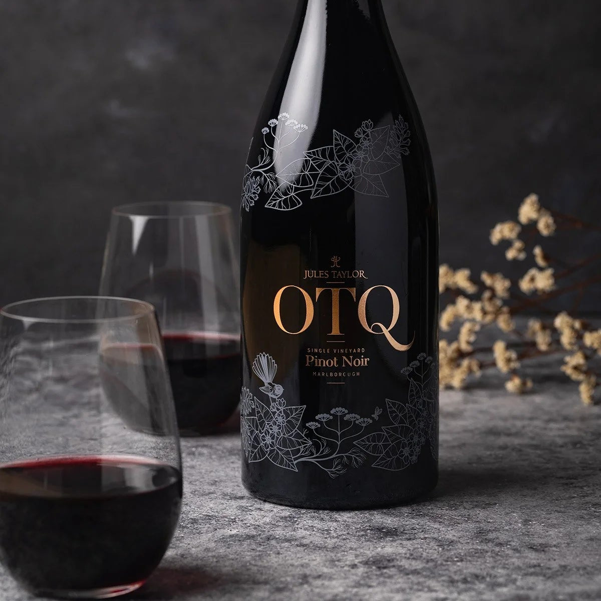 Load image into Gallery viewer, Bottle of Jules Taylor OTQ Pinot Noir wine with a glass on a dark background