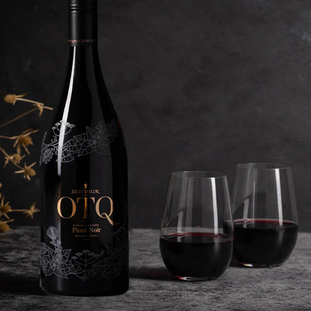 Load image into Gallery viewer, OTQ Pinot Noir wine bottle with two glasses of red wine on a dark background