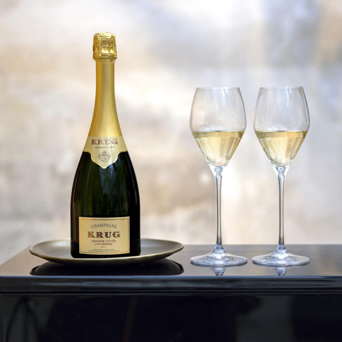 Load image into Gallery viewer, Krug Grande Cuvee champagne bottle with two glasses on a reflective surface