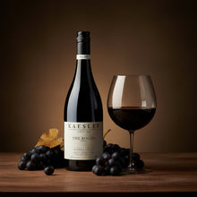 Load image into Gallery viewer, Bottle of Kaesler The Bogan Shiraz wine with a glass and grapes on a wooden table