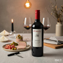 Load image into Gallery viewer, Bottle of Kalleske Merchant Cabernet Sauvignon wine on a table with glasses, food, and decor.