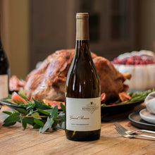 Load image into Gallery viewer, Bottle of Kendall-Jackson wine on a table with a roasted turkey and holiday decorations in the background.