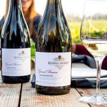 Load image into Gallery viewer, Three bottles of Kendall-Jackson wine on a wooden table with a blurred background