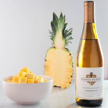 Load image into Gallery viewer, Bottle of Kendal Jackson Chardonnay with pineapple and mango on a light background