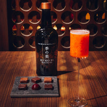 Load image into Gallery viewer, Bottle of KI NO BI gin with a cocktail and chocolates on a wooden table.