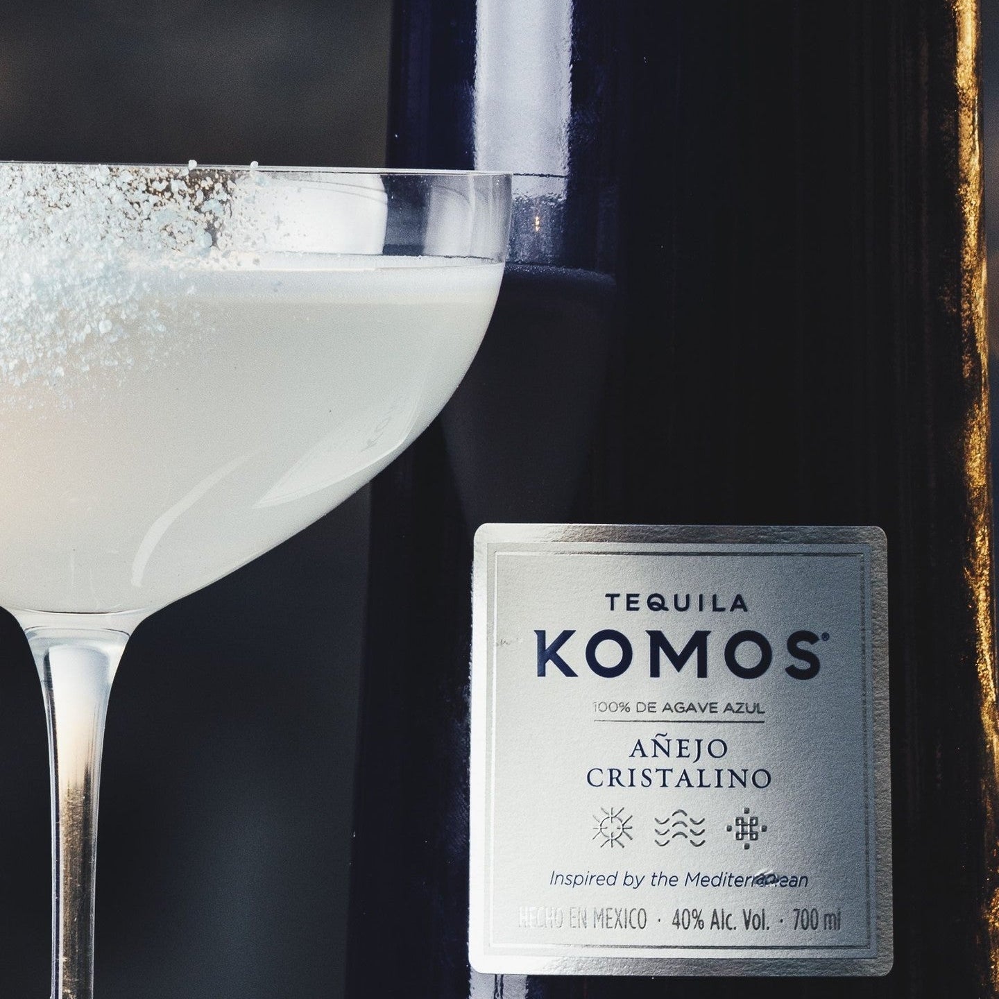 Load image into Gallery viewer, Tequila Komos bottle with a cocktail glass filled with a frothy cocktail.