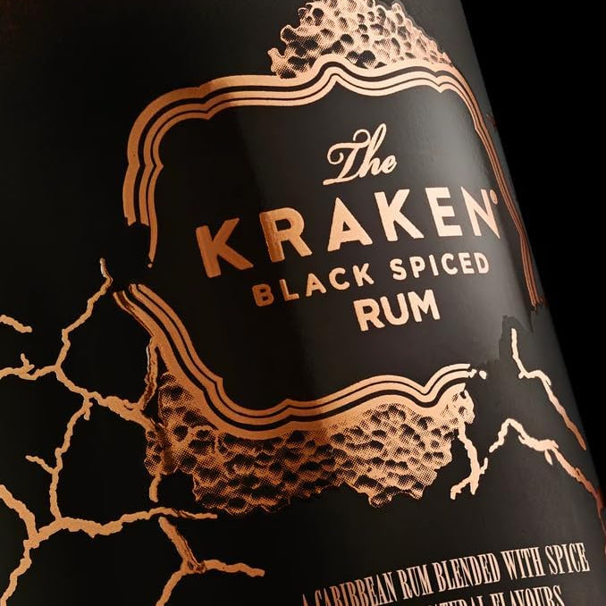 Kraken Black Spiced Rum bottle with gold text and design on a black background